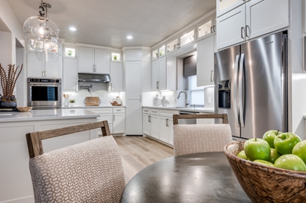 After: Kitchen interior design after renovation featuring white cabinetry and seamless backsplash in Arlington TX