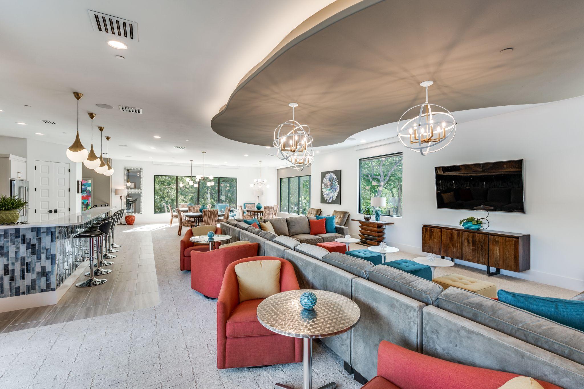 Open-concept living and lounge space with custom upholstered seating by Landry Designs