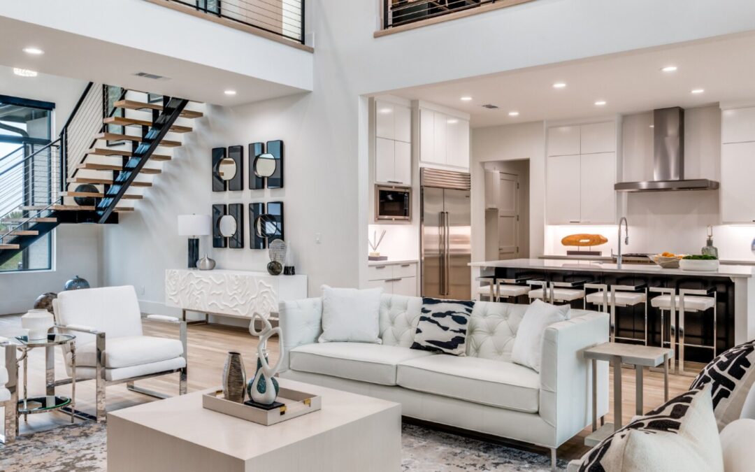 Bright open-concept luxury great room with layered ambient and pendant lighting by Landry Designs