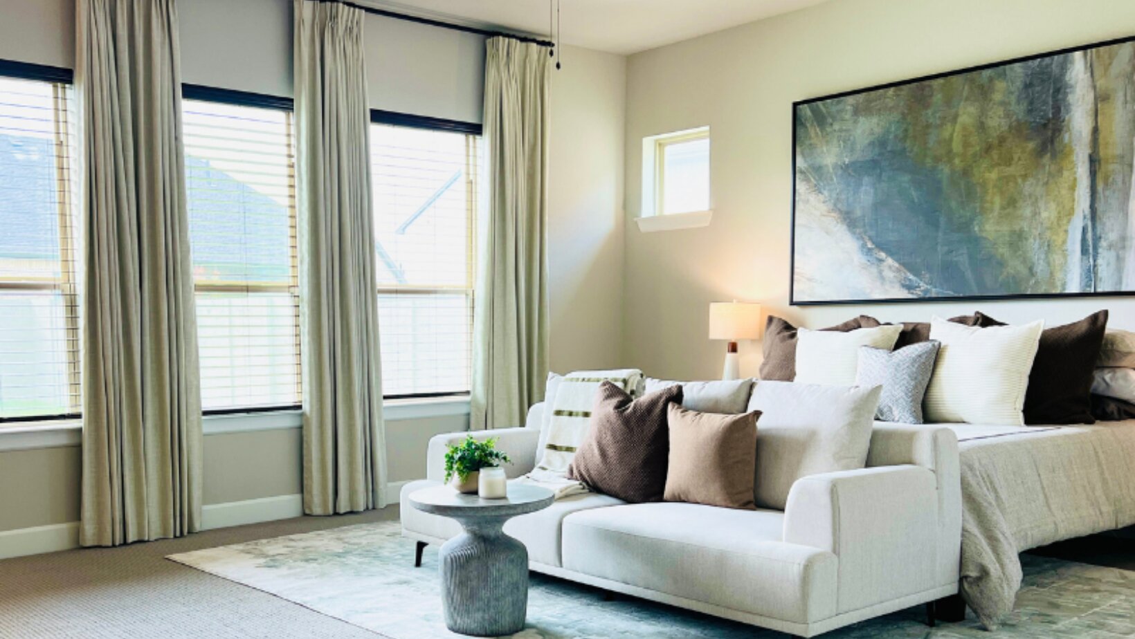 Restful master suite seating area with earthy neutral tones and soft natural light by Landry Designs