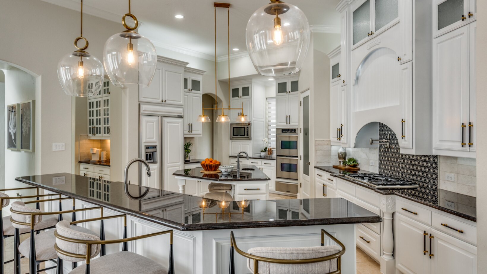 The Power of Ambient Lighting in Interior Design: Create a Cozy Atmosphere with Layered Lighting 1 Luxury white kitchen with glass globe pendant lighting and under-cabinet task lighting by Landry Designs