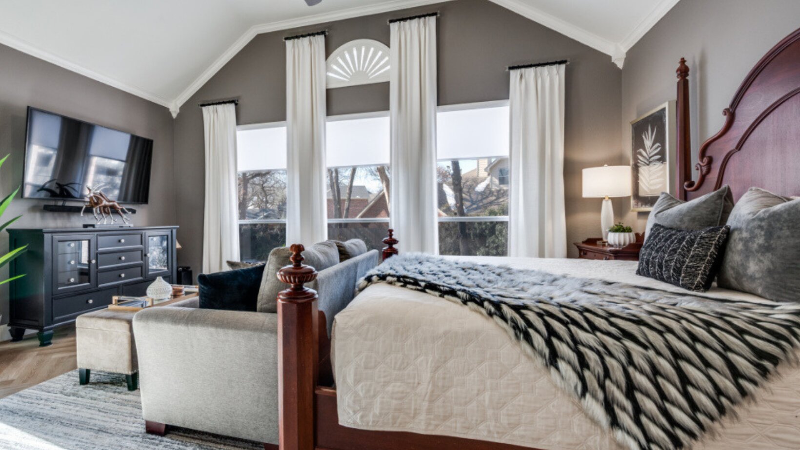 Layered master bedroom with warm taupe walls, plush textiles and soft drapery for a quiet, calming atmosphere by Landry Designs