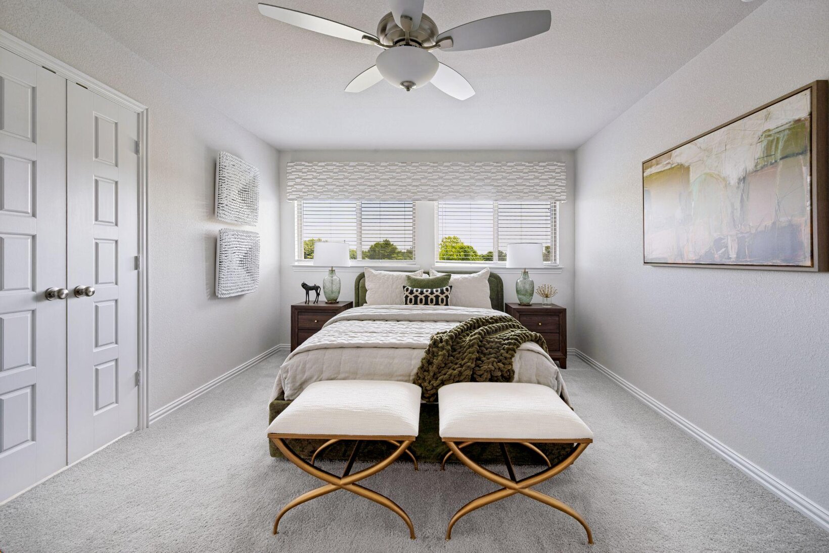 Light-filled bedroom with a warm neutral palette, soft greige walls and layered bedding by Landry Designs